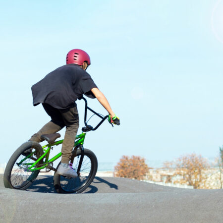 Boy in bike helmet on bmx track